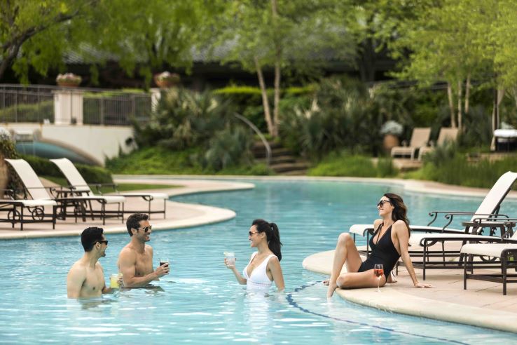 Family playing in the pool at the Ritz-Carlton